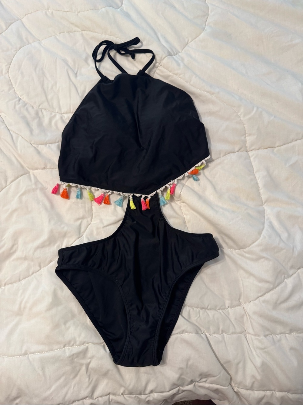 Tankini, the middle piece covers the bellybutton.  Colorful Tassel Trim